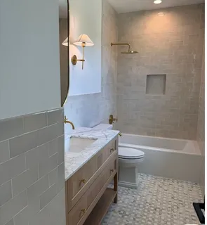 a bathroom with a sink a toilet and shower