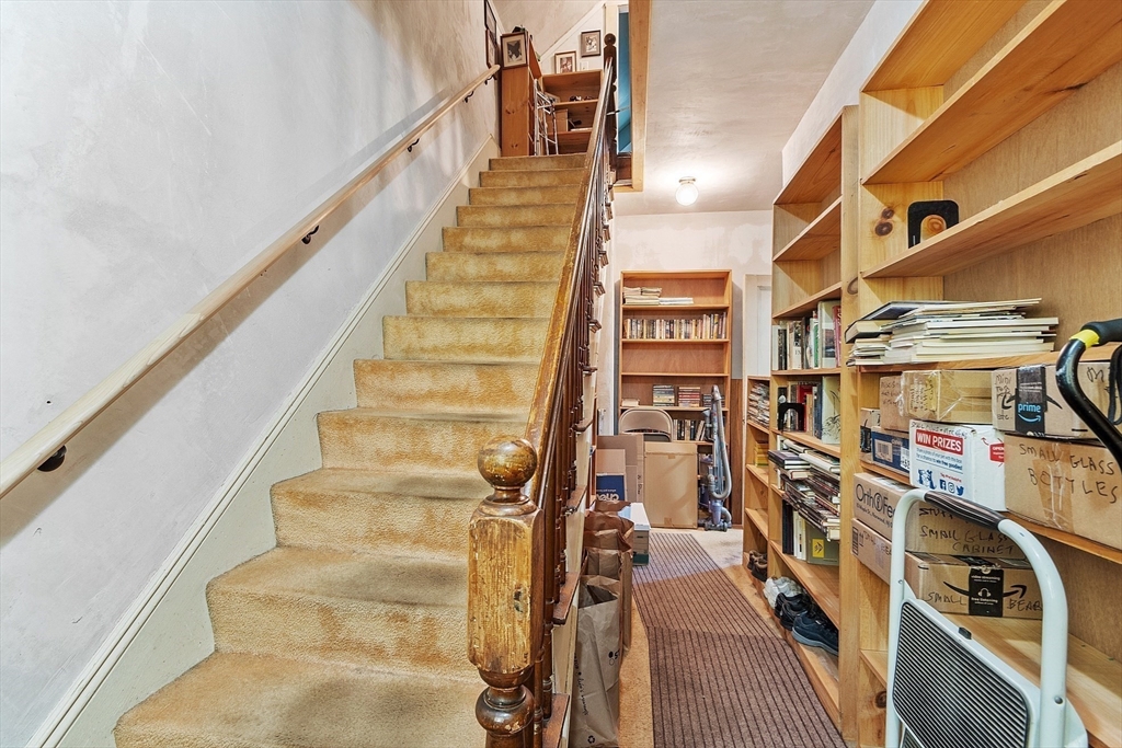 51 Farwell Road Tyngsborough, MA 01879 - Photo 11 of 33 a view of staircase with lots of frames on wall and a potted plant