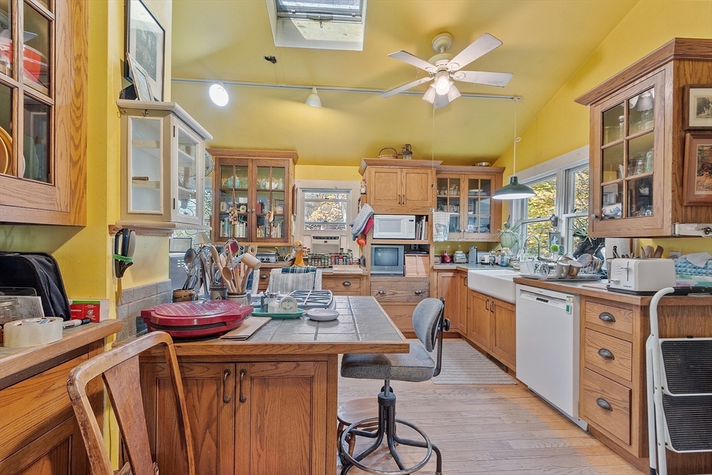 51 Farwell Road Tyngsborough, MA 01879 - Photo 3 of 33 a kitchen with stainless steel appliances kitchen island granite countertop a table chairs in it and a sink