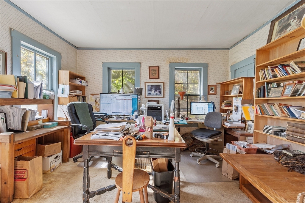 51 Farwell Road Tyngsborough, MA 01879 - Photo 8 of 33 a view of a workspace with furniture and a bookshelf