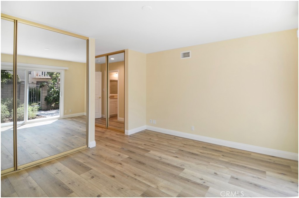 55 Oak Tree Lane Irvine, CA 92612 - Photo 14 of 27 an empty room with wooden floor and windows