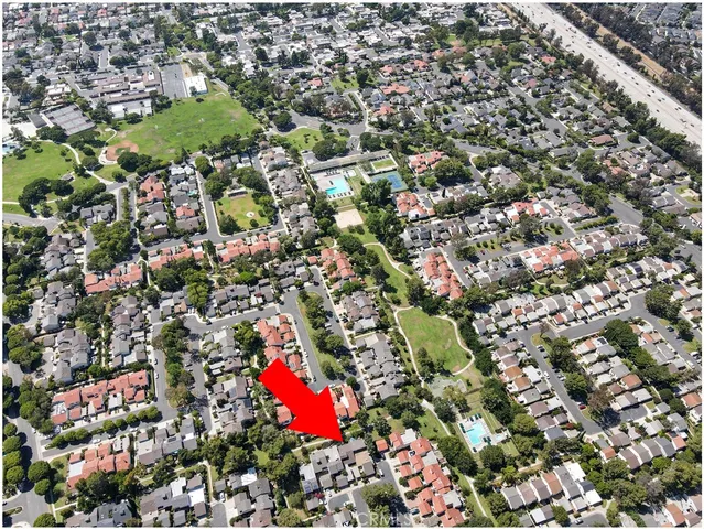 an aerial view of residential houses with outdoor space and street view