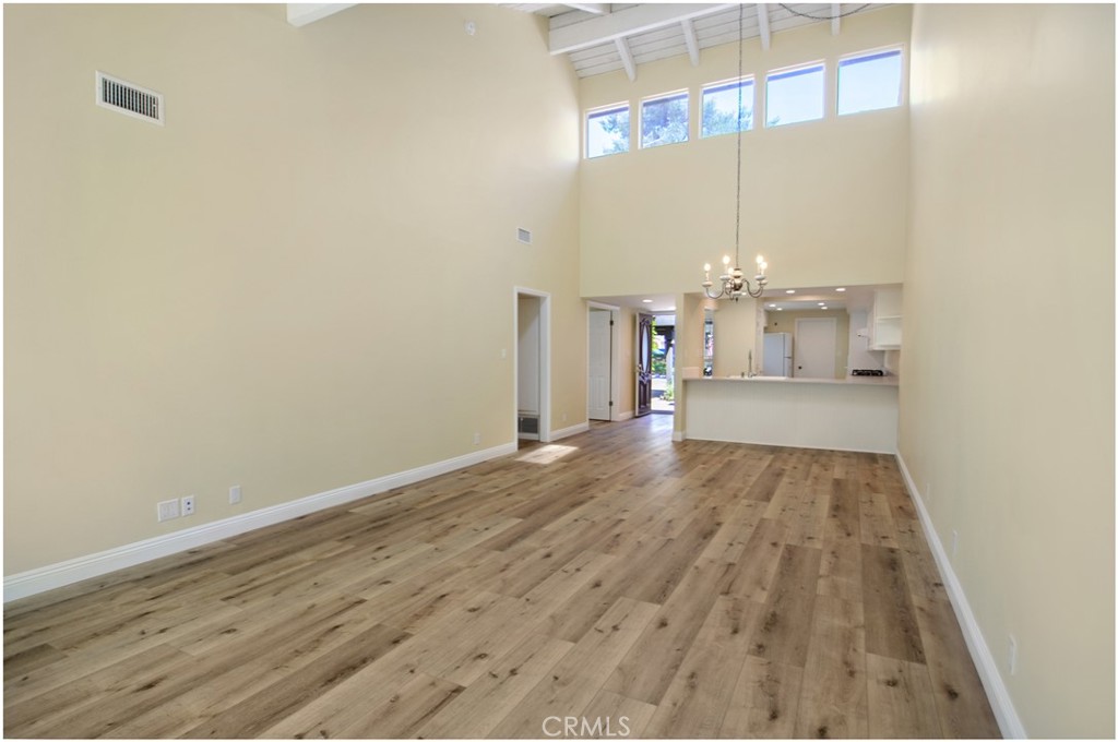 55 Oak Tree Lane Irvine, CA 92612 - Photo 4 of 27 a view of a room with wooden floor and windows