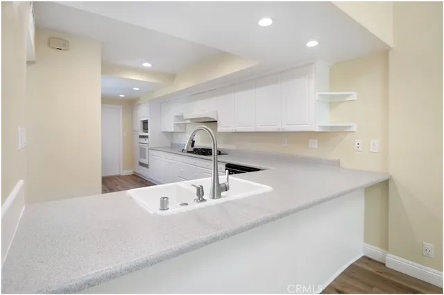 a kitchen with a sink and a refrigerator