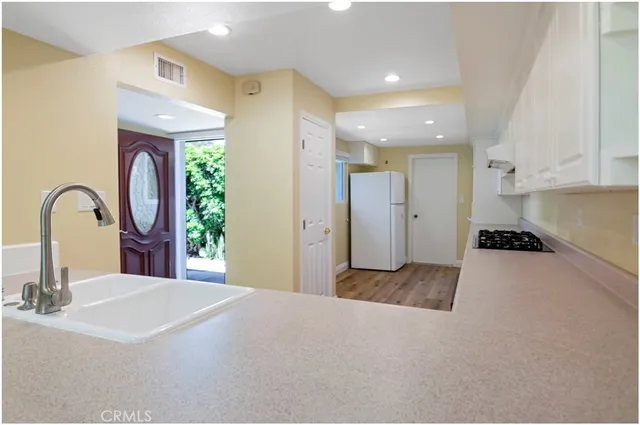 a spacious bathroom with a granite countertop sink a toilet and a mirror