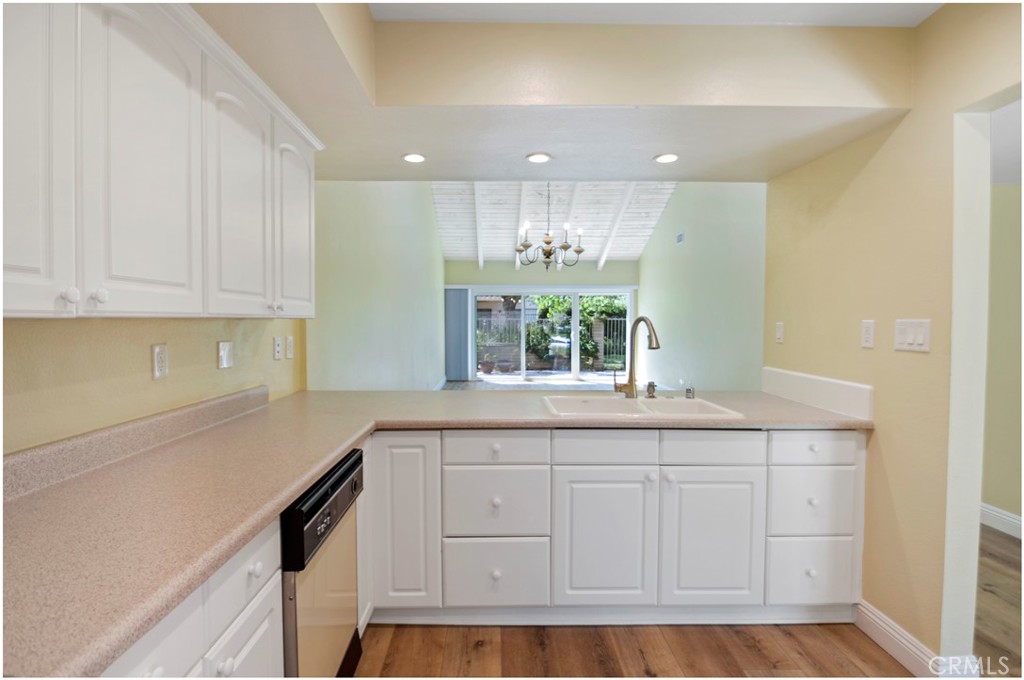 55 Oak Tree Lane Irvine, CA 92612 - Photo 8 of 27 a kitchen with white cabinets and sink