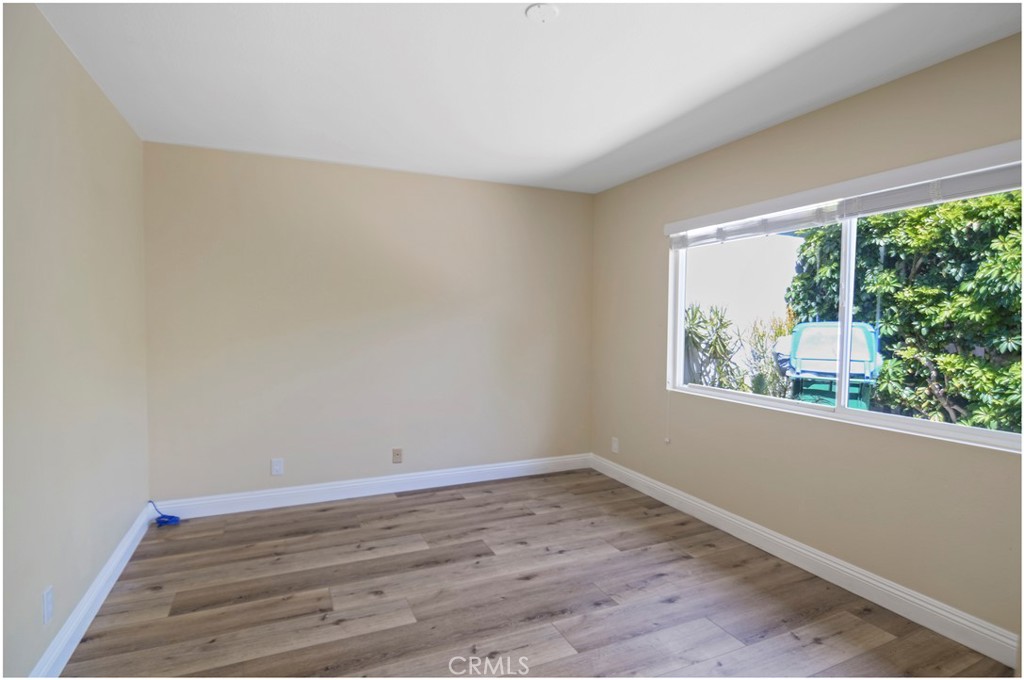 55 Oak Tree Lane Irvine, CA 92612 - Photo 9 of 27 wooden floor in an empty room with a window