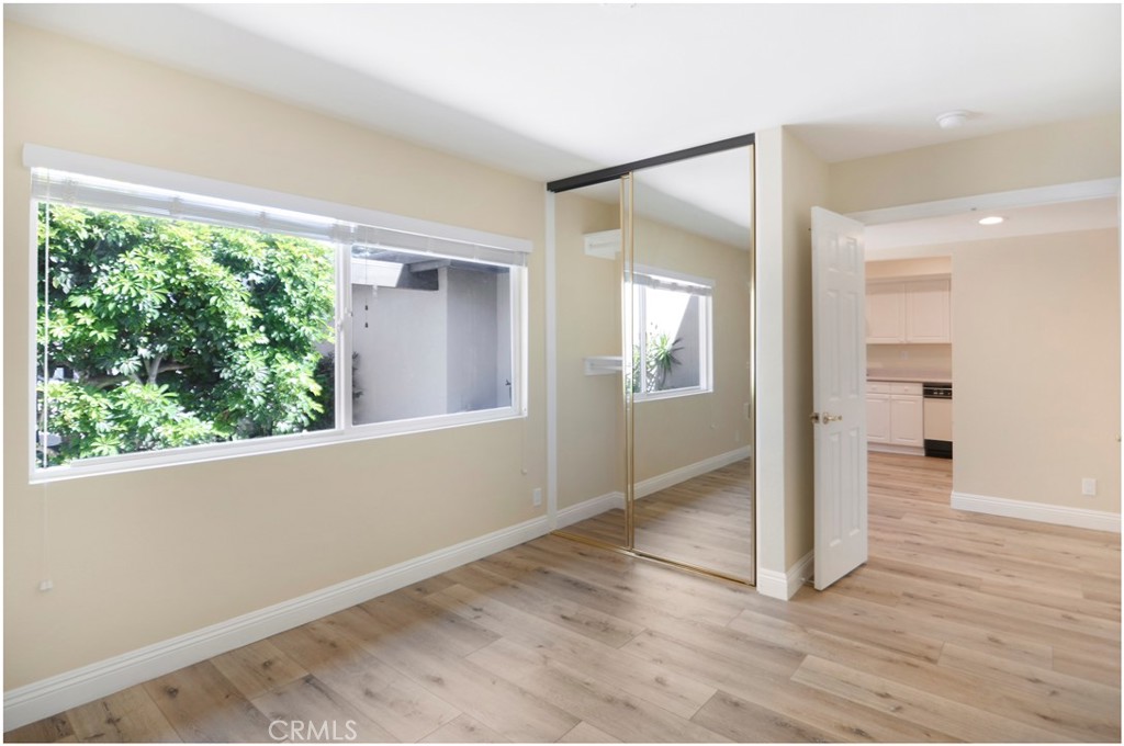 55 Oak Tree Lane Irvine, CA 92612 - Photo 10 of 27 an empty room with wooden floor and windows