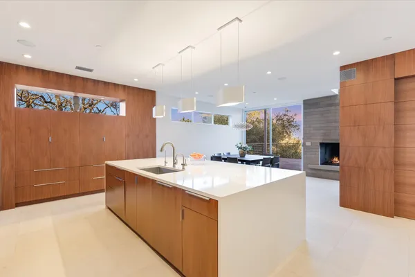 a large kitchen with kitchen island a dining table and chairs