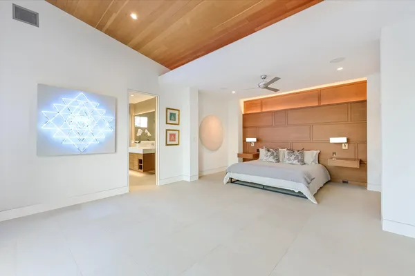 a spacious bedroom with a large bed and a window