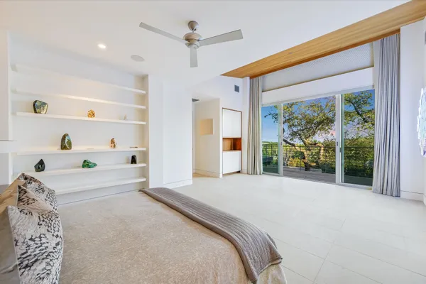 a view of a room with a large window and front door
