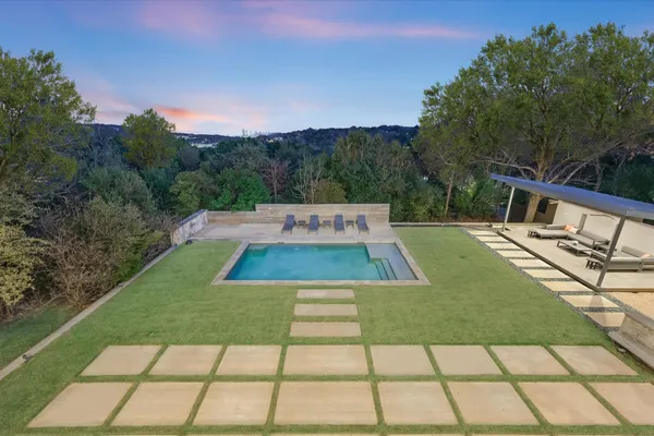 a living room with patio furniture and a potted plant