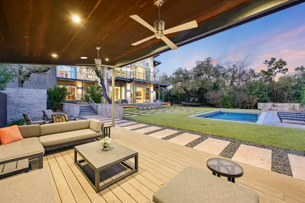 a view of yard with swimming pool outdoor seating and barbeque oven