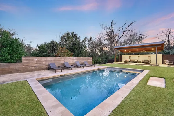 a view of a swimming pool with lounge chair