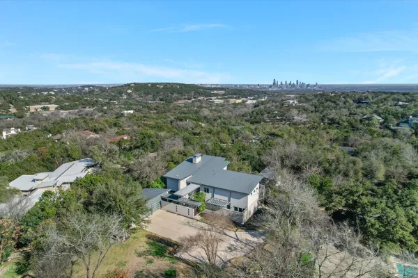 an aerial view of a house with a yard