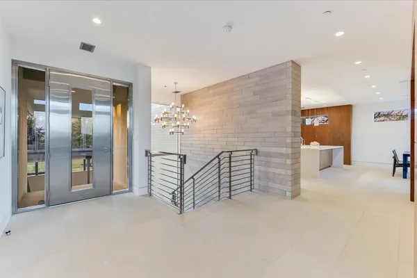a large kitchen with stainless steel appliances a large counter top