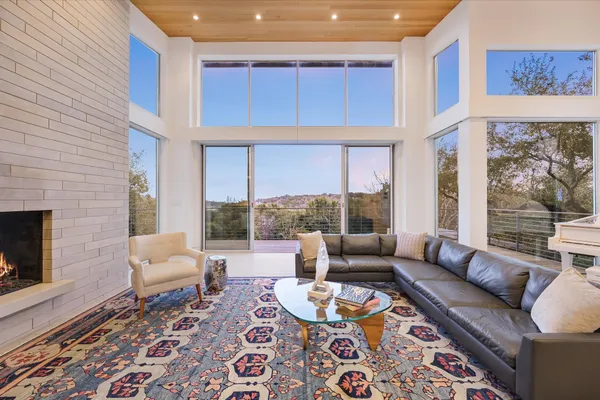 a view of a balcony with couches and city view