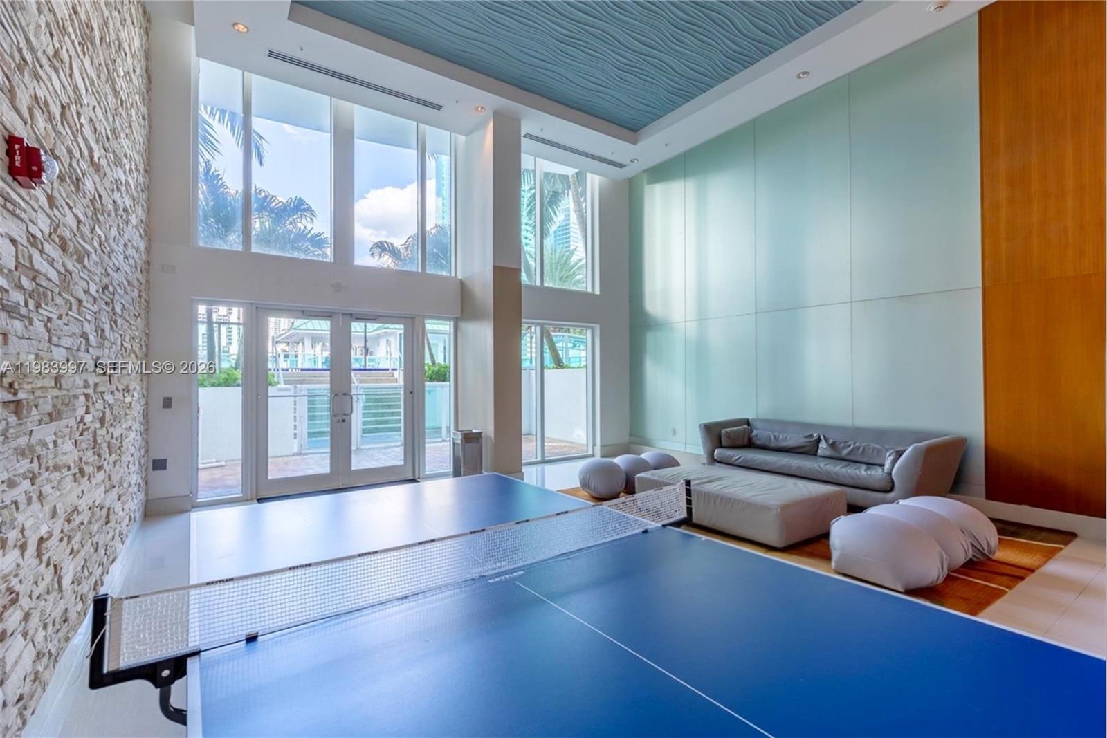 41 Southeast 5th Street, Unit 1106 Miami, FL 33131 - Photo 4 of 10 a living room with furniture and large windows