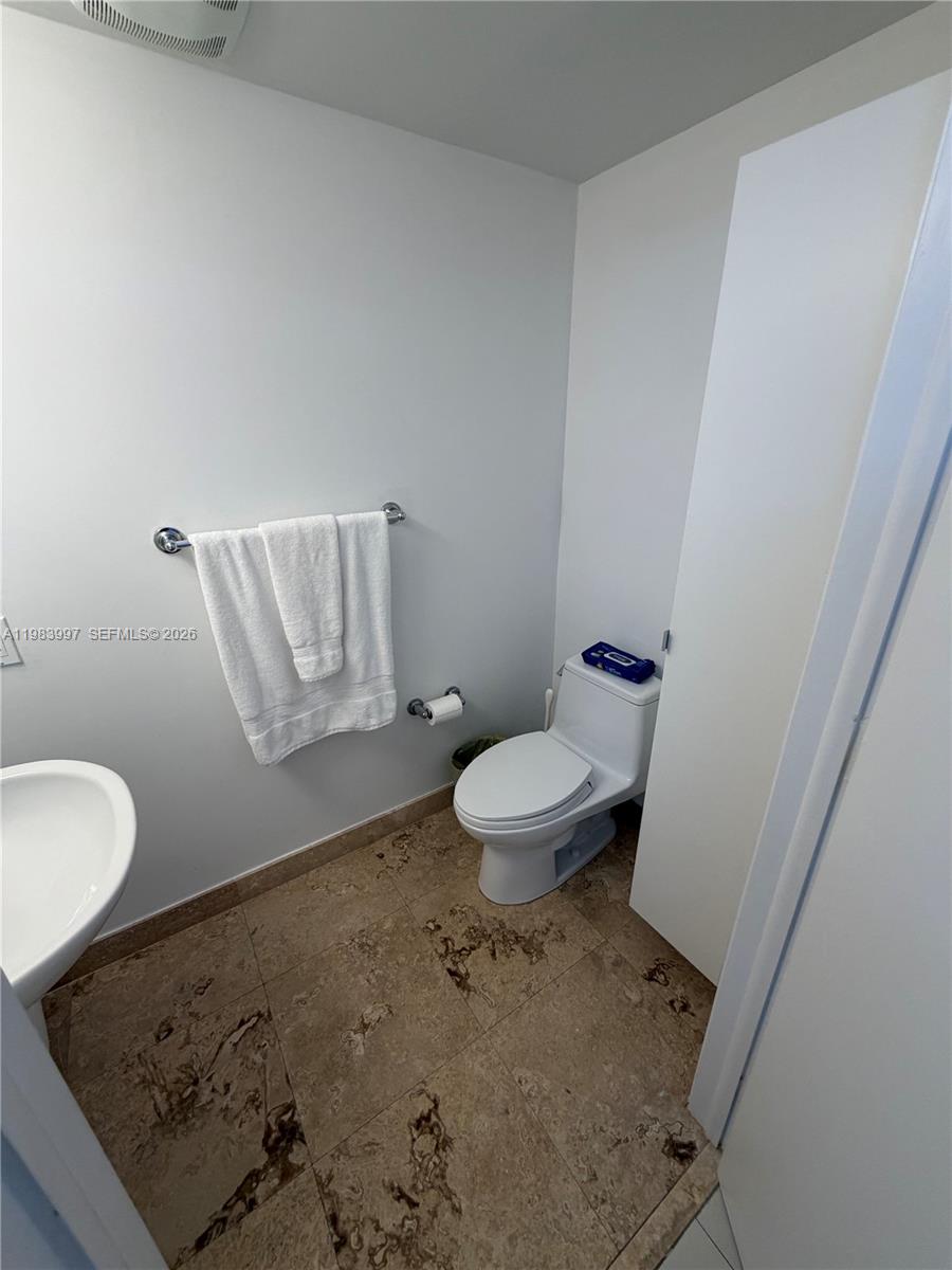 41 Southeast 5th Street, Unit 1106 Miami, FL 33131 - Photo 8 of 10 a bathroom with a sink and a toilet