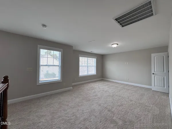 a spacious bathroom with a granite countertop sink mirror and shower