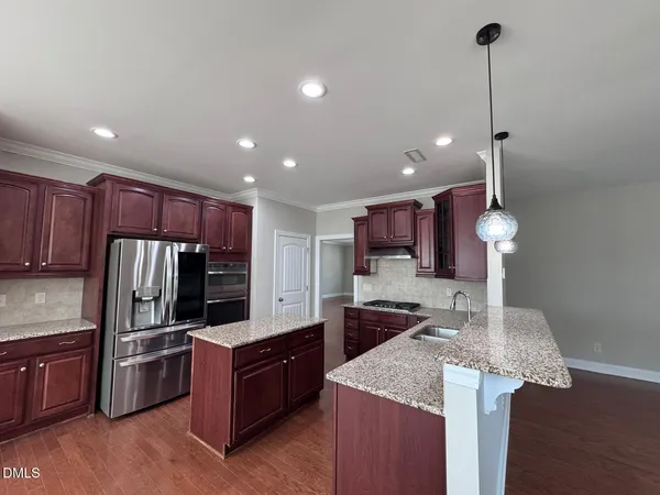 a view of empty room with ceiling fan and window
