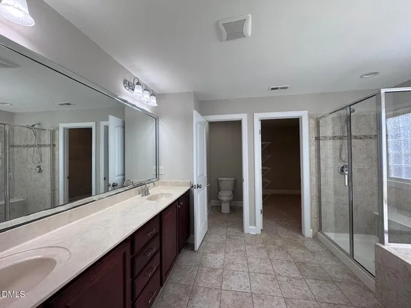 a kitchen with kitchen island granite countertop wooden cabinets a sink and stainless steel appliances