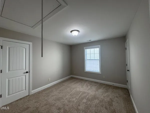 a view of a livingroom with furniture and a window