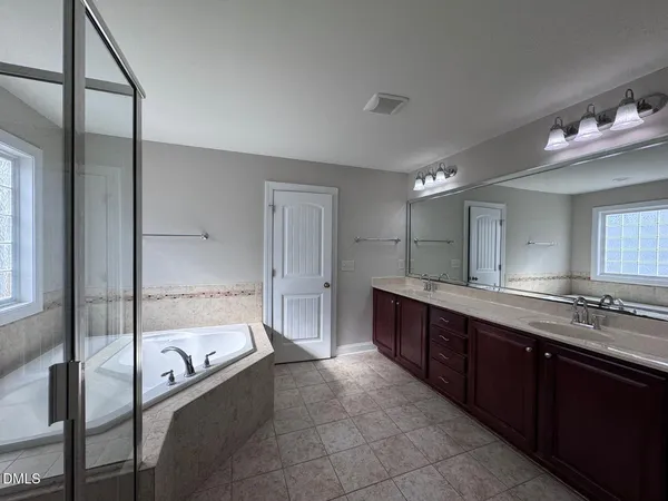 a bathroom with a sink double vanity and a mirror
