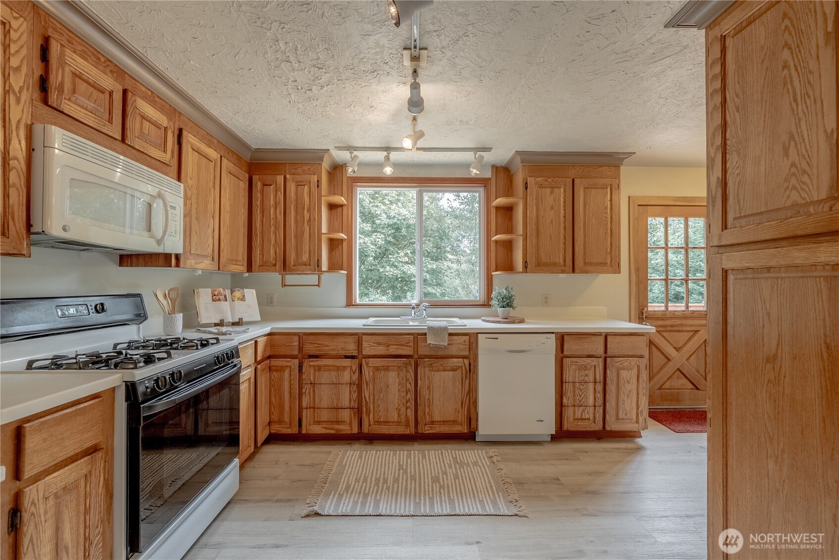 20006 68th Avenue Northeast Kenmore, WA 98028 - Photo 11 of 40 a kitchen with stainless steel appliances granite countertop a stove a sink and a microwave