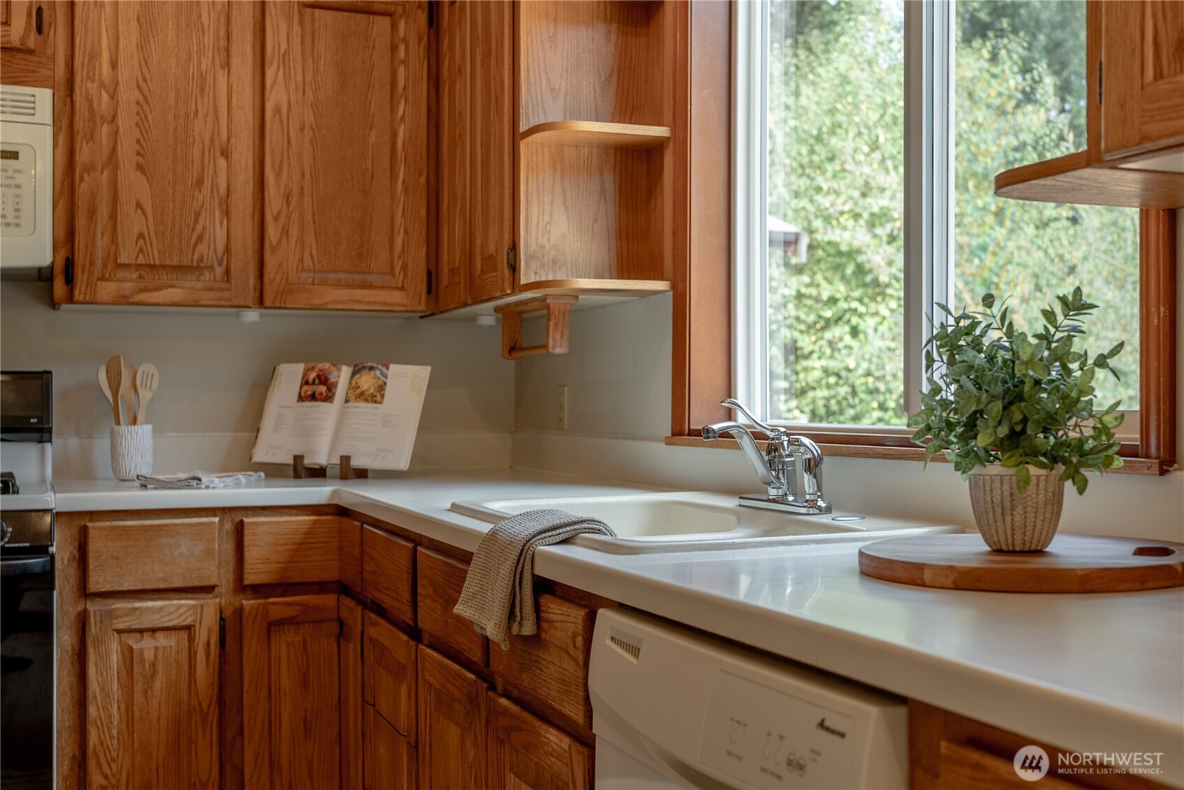20006 68th Avenue Northeast Kenmore, WA 98028 - Photo 12 of 40 a kitchen with stainless steel appliances granite countertop a sink a counter space and cabinets