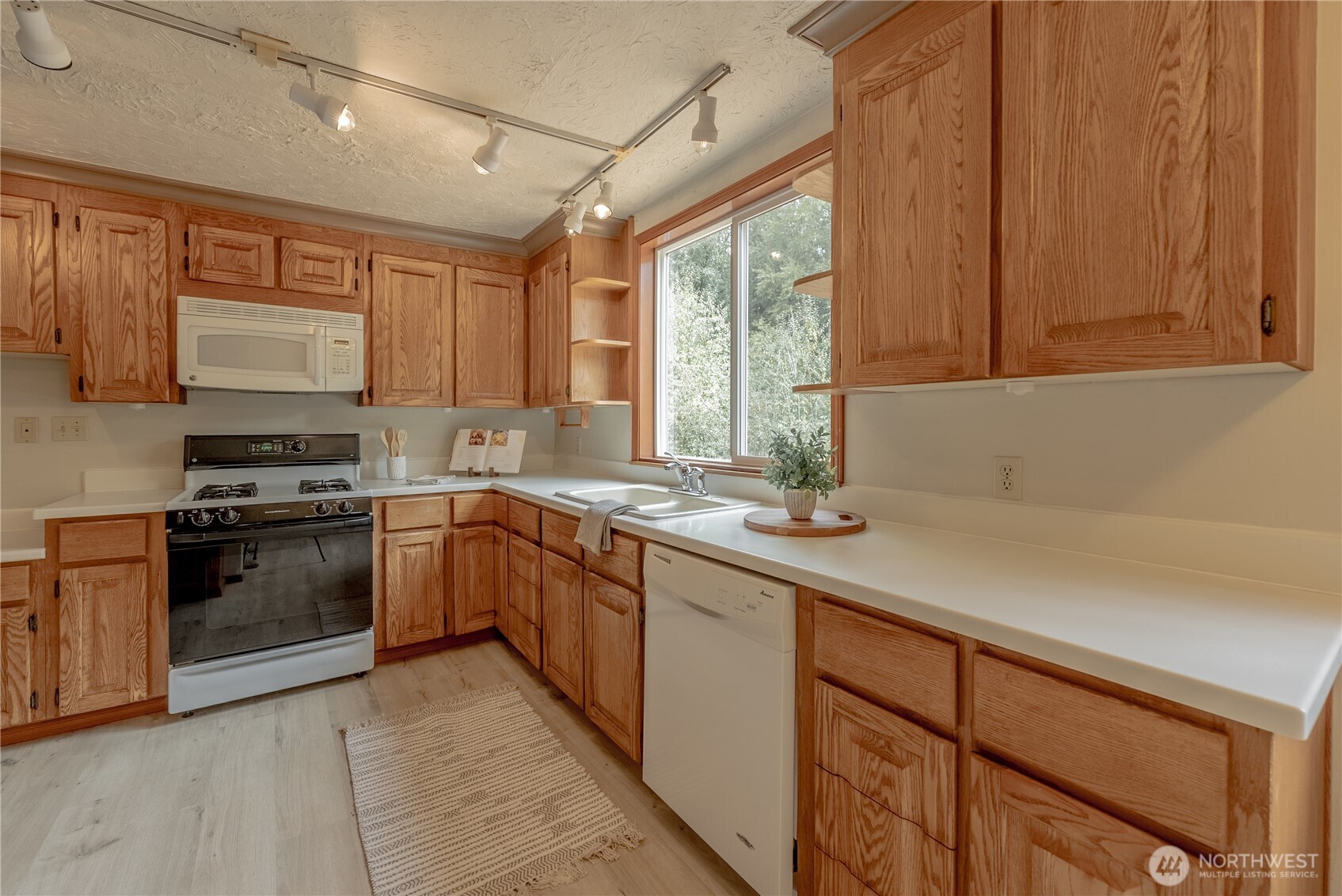 20006 68th Avenue Northeast Kenmore, WA 98028 - Photo 13 of 40 a kitchen with stainless steel appliances granite countertop a sink stove and cabinets