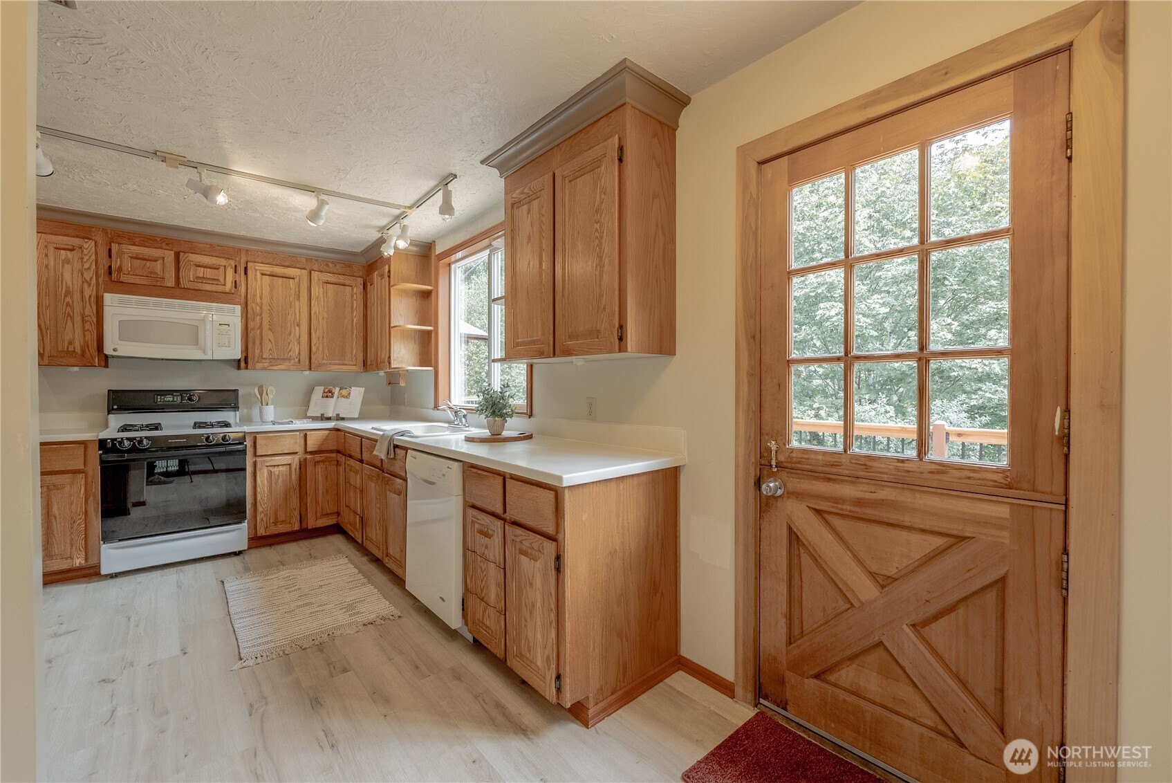 20006 68th Avenue Northeast Kenmore, WA 98028 - Photo 15 of 40 a kitchen with a stove a sink and a refrigerator
