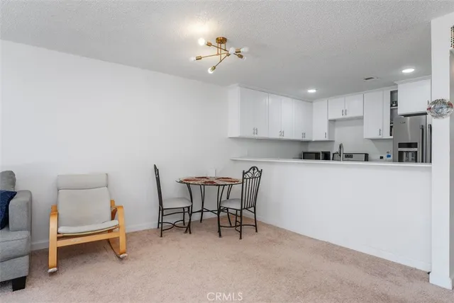 a living room with furniture a dining table and chairs