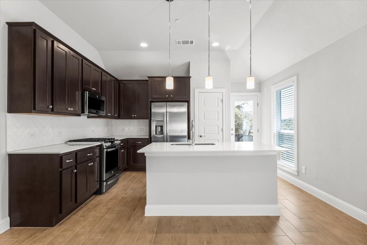 2605 Sam Bass Road, Unit 50 Round Rock, TX 78681 - Photo 11 of 30 Upgraded backsplash and countertops, along with tons of cabinets
