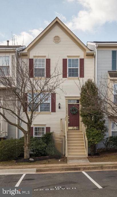 a view of a white house with a street