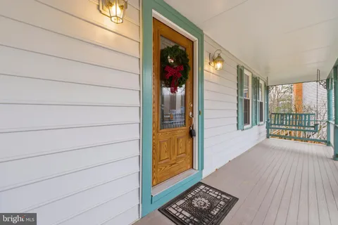 a view of a hallway with wooden floor and a window