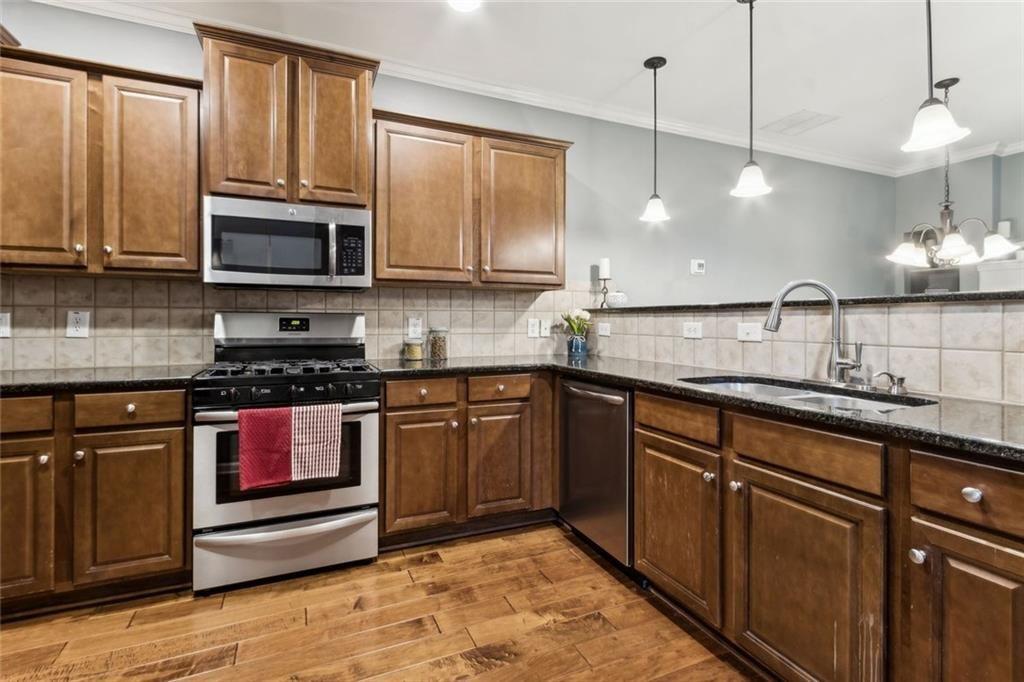 149 Trailside Circle Hiram, GA 30141 - Photo 15 of 35 a kitchen with stainless steel appliances granite countertop a sink a stove and a microwave