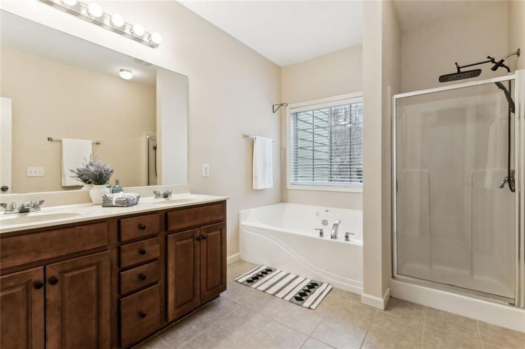 149 Trailside Circle Hiram, GA 30141 - Photo 19 of 35 a spacious bathroom with a tub double sink shower and mirror