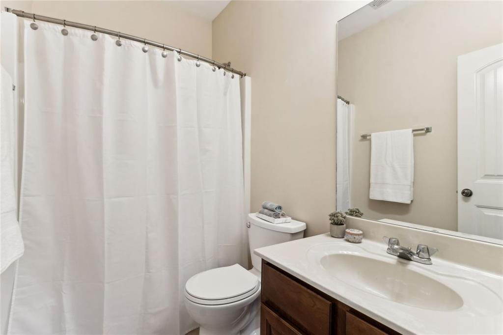149 Trailside Circle Hiram, GA 30141 - Photo 25 of 35 a bathroom with a sink a toilet and a mirror