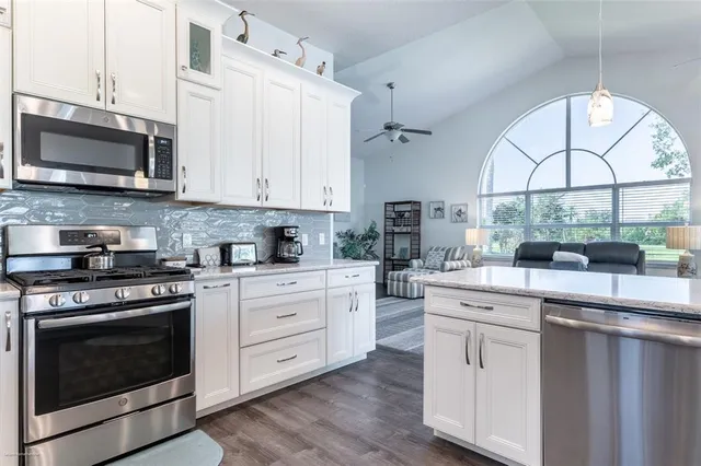 a bathroom with a granite countertop sink a toilet and a bathtub