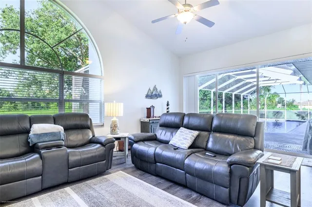 a view of a bedroom with a window and wooden floor