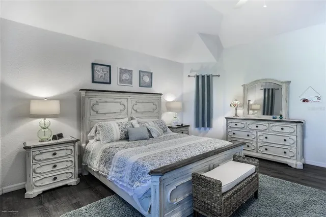 a bathroom with a granite countertop sink mirror vanity and toilet