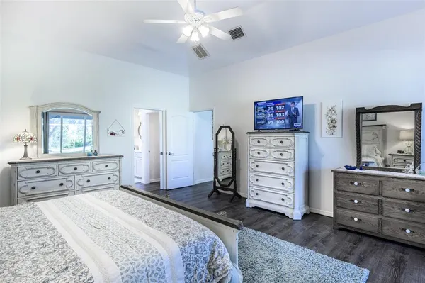 a bathroom with a granite countertop sink a toilet and a mirror