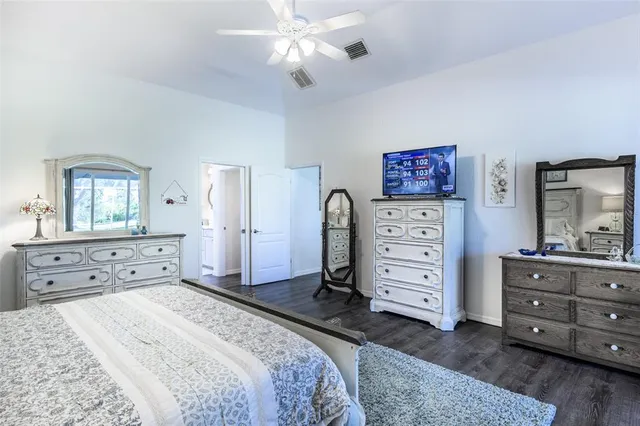 a bathroom with a granite countertop sink a toilet and a mirror