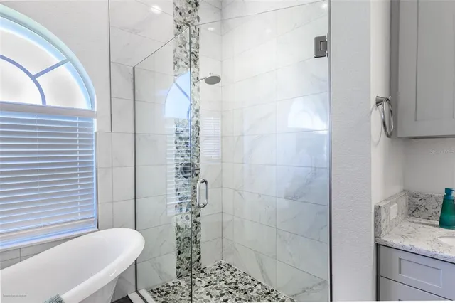 a bedroom with a bed and a night stand