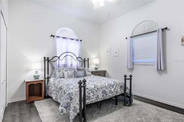 a front view of a house with a yard and potted plants