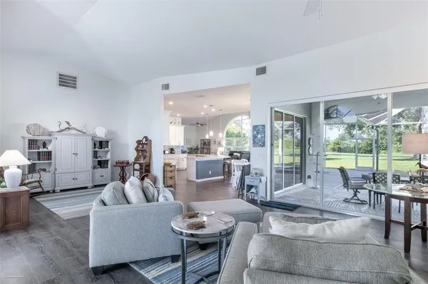 a kitchen with granite countertop a refrigerator stove and sink