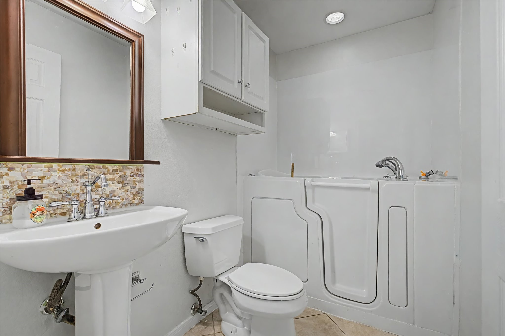 413 Farrer Street Angleton, TX 77515 - Photo 36 of 43 a bathroom with a toilet sink and mirror