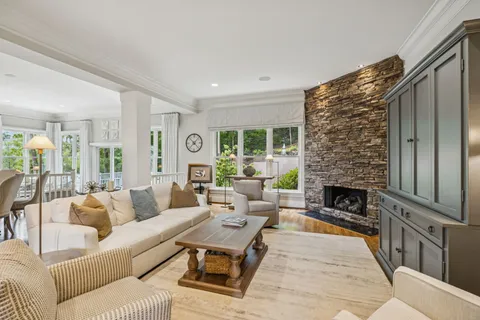 a kitchen with stainless steel appliances granite countertop a kitchen island a table and chairs in it