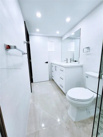a bathroom with a sink toilet and a mirror